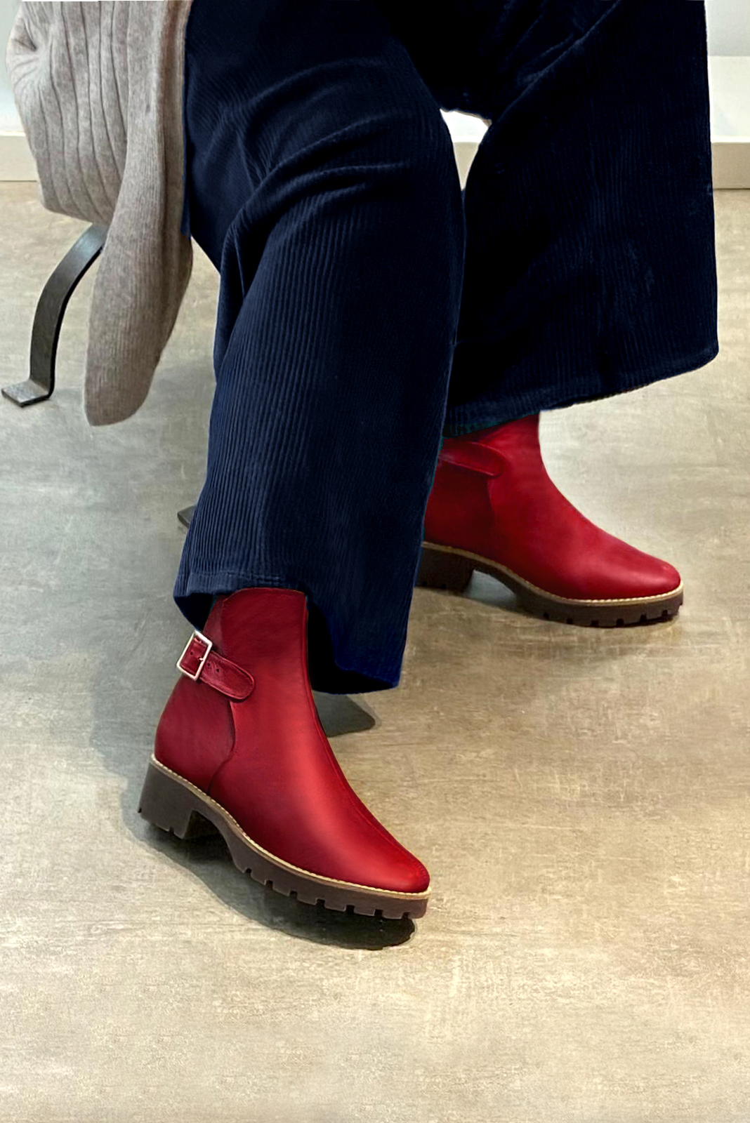 Cardinal red women's ankle boots with buckles at the back. Round toe. Low rubber soles. Worn view - Florence KOOIJMAN